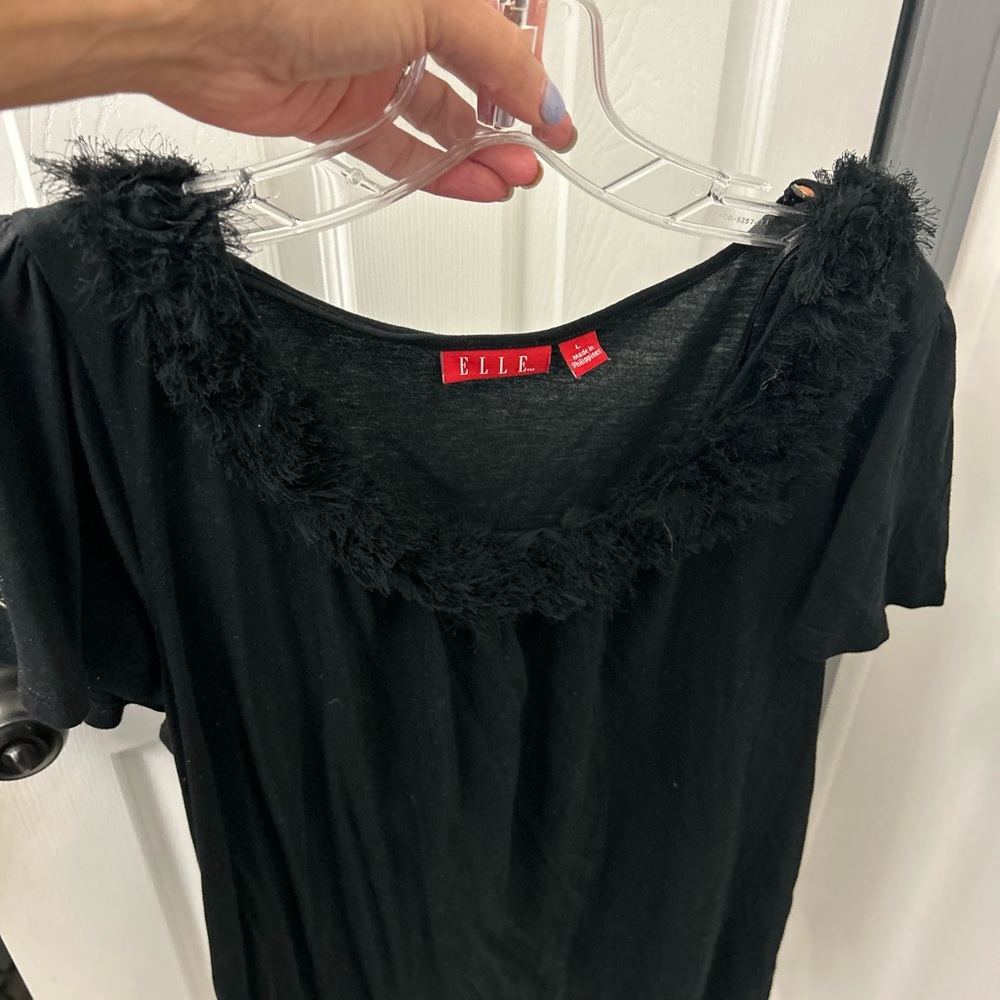 NWOT ELLE black tee with fringe detail around the collar.